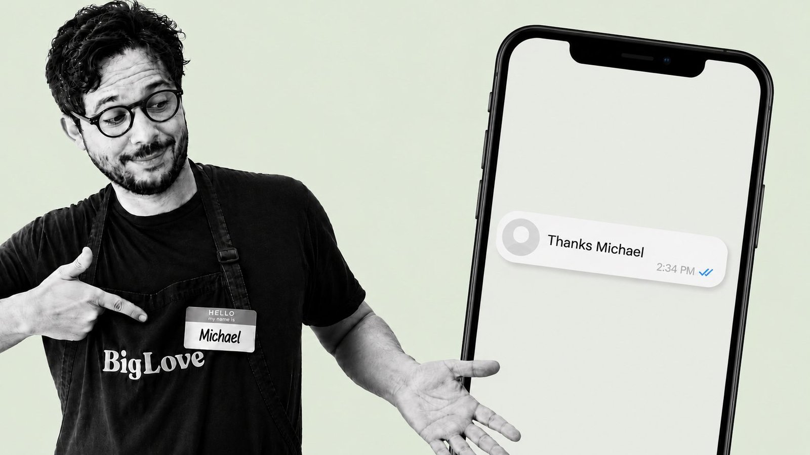 Michael Philippou, wearing a Big Love name tag, gesturing toward a phone screen showing a text message reply that reads Thanks Michael.